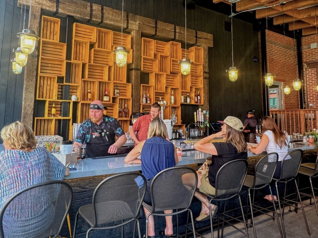 Butcher and the Boar patio with bartenders and patrons